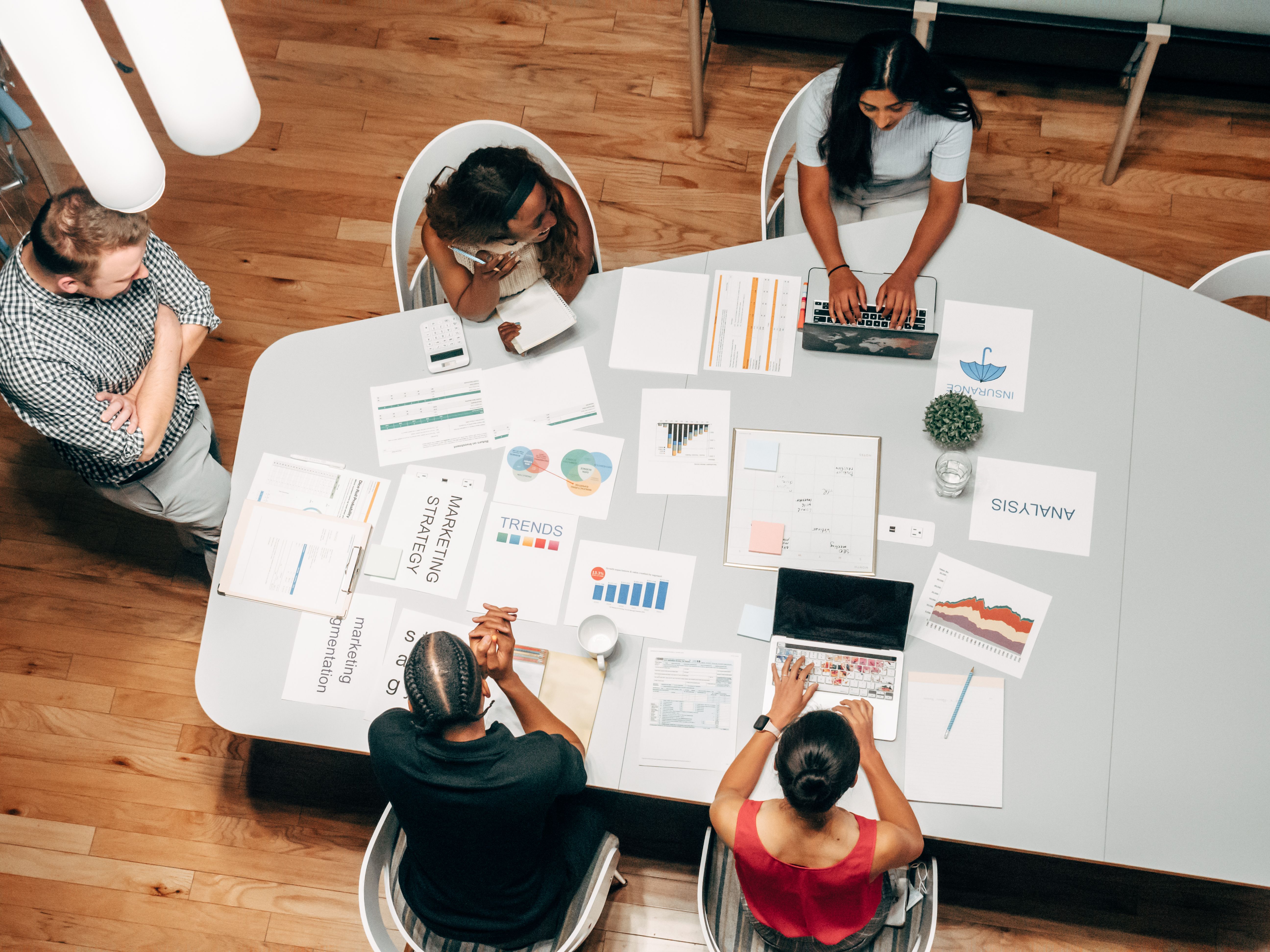 Marketing team reviewing search performance on laptop