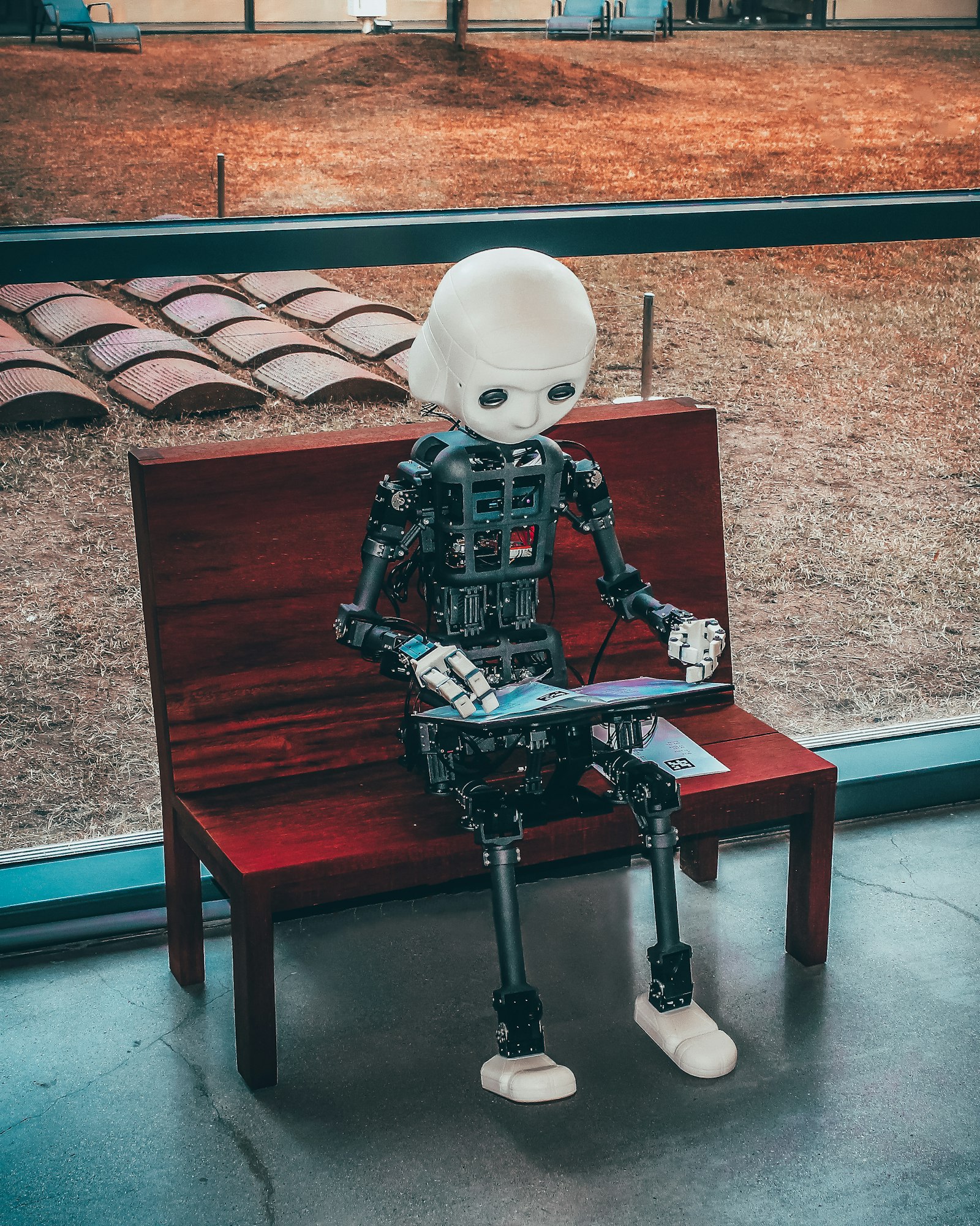 Humanoid robot working on a laptop