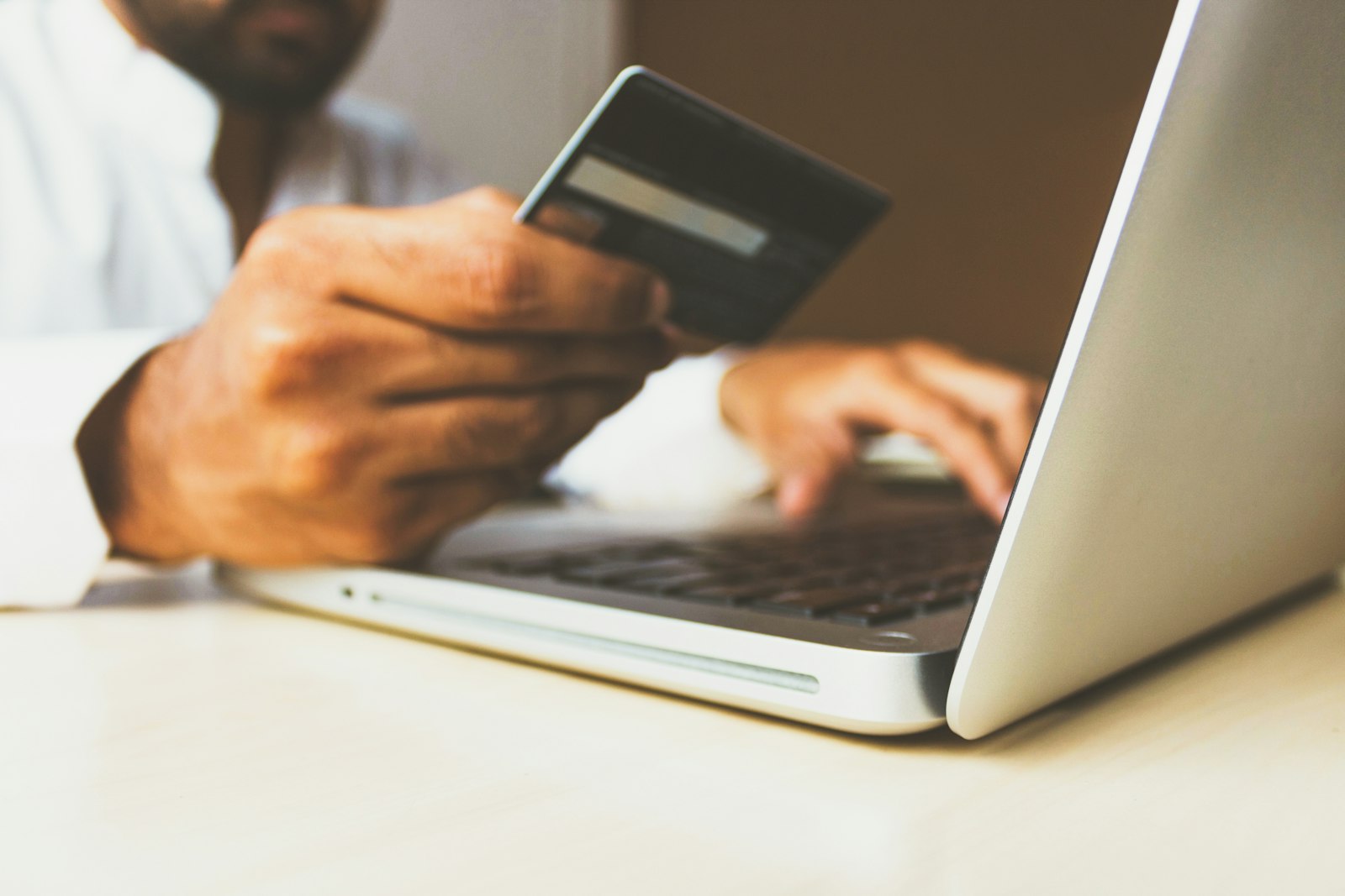 Customer paying online with card and laptop