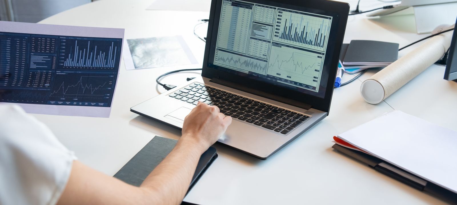 A business owner reviewing marketing performance charts on a laptop