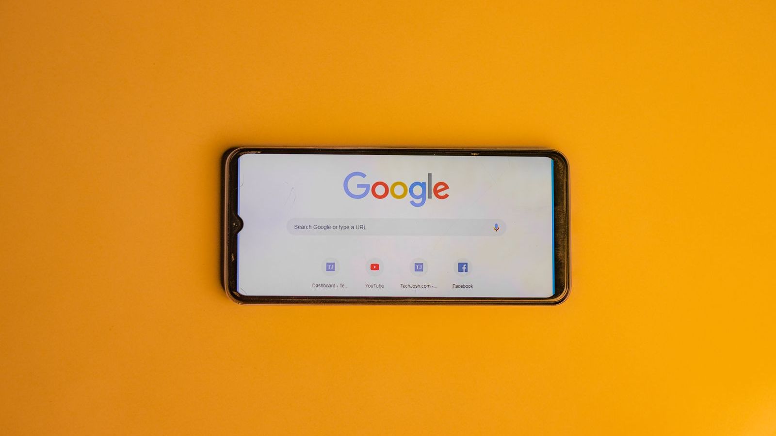 A smartphone showing the Google search page, where Google Ads campaigns appear