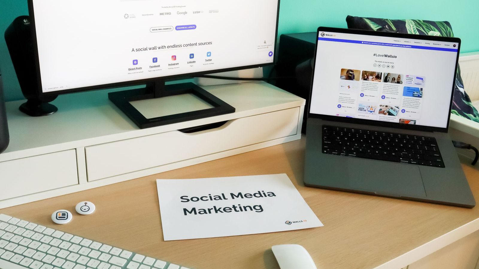 A laptop and monitor set up for planning and scheduling social media content