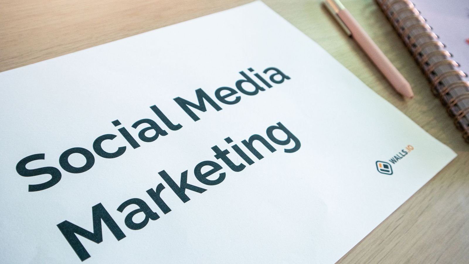 A social media marketing plan written in a notebook on a desk